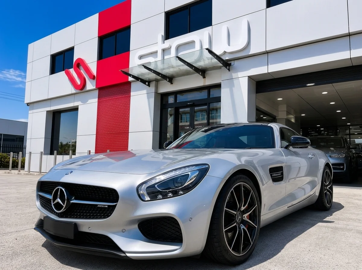 Pristine restored silver sports car parked outside Stow Smash Repairs facade panels