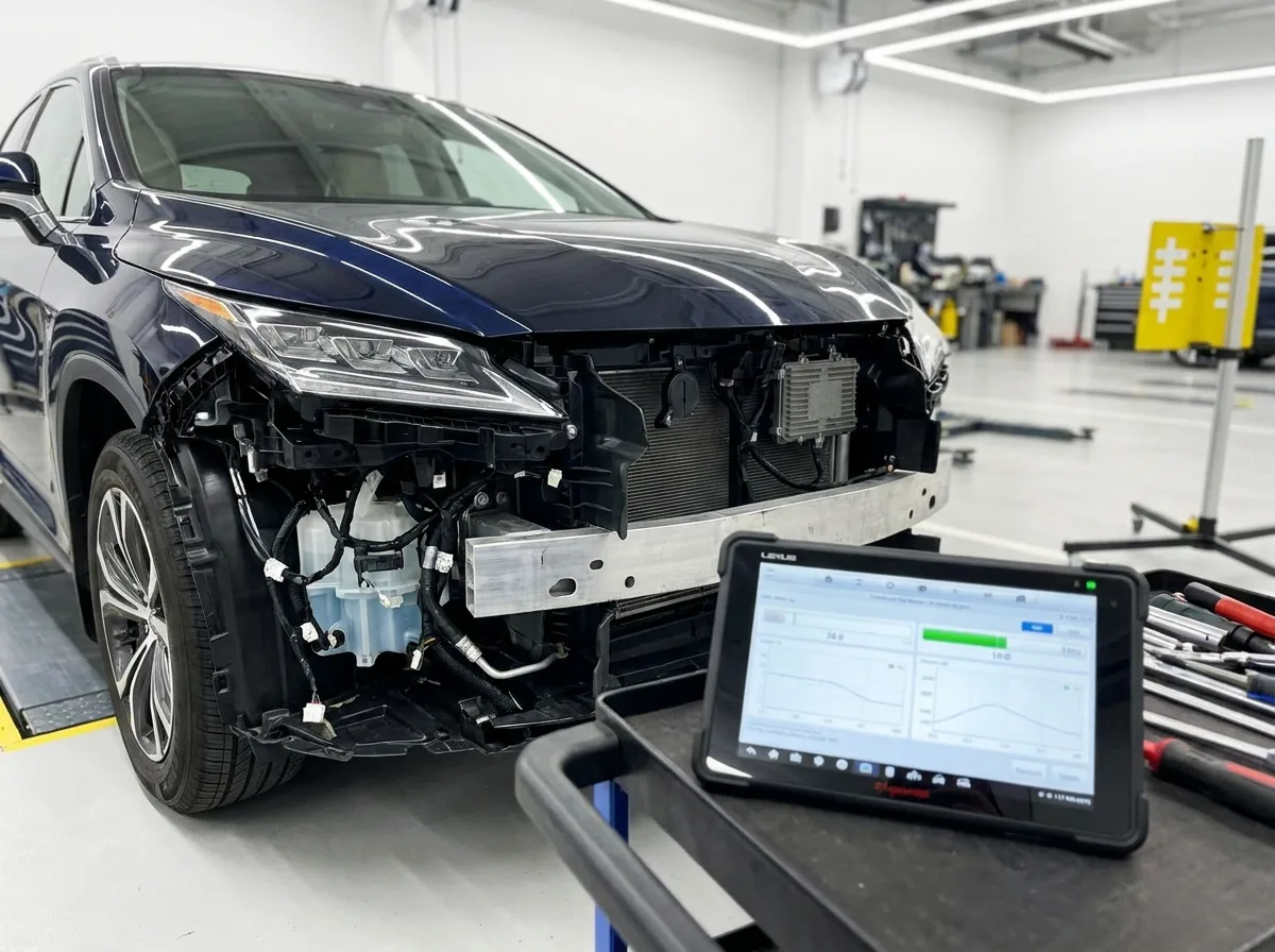 Sensor array and diagnostic tablet during recalibration on a navy Lexus SUV